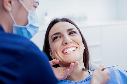 Smiling patient with dental assistant
